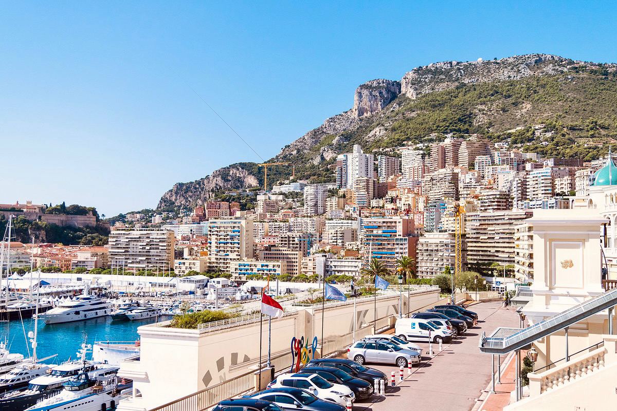 Monaco harbour in daylight — yachts, Port Hercule, the cliff and buildings stacked impossibly high
